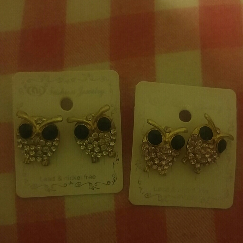 Owl earrings . one pink.one clear diamond color.